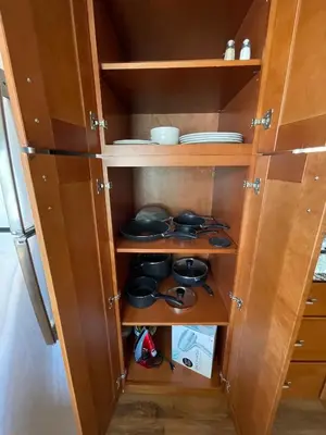 a cupboard with pots and pans in it at Your home away from home in beautiful Santa Monica in Los Angeles