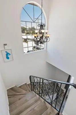 a chandelier in a staircase with a window at Spacious Private gated modern loft close to Universal Studio and Hollywood in Los Angeles