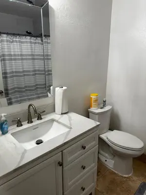 a bathroom with a sink and a toilet and a mirror at Buxton Mirror Room in Rialto