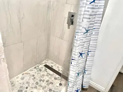 a shower with blue stars on the shower curtain at Cozy Room with Private bathroom & Entrance in Carson