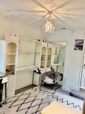 a room with a chair and a chandelier at Private Room View Gated 2Acre Estate - Female Share Indoor - Men Share Outdoor - SD in Encino