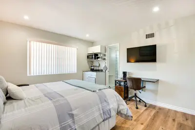 a bedroom with a bed and a desk and a television at Cozy Simi Valley Studio Less Than 10 Mi to Hiking and Golf in Simi Valley