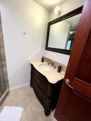 a bathroom with a sink and a mirror at Holiday at Halliday in Los Angeles