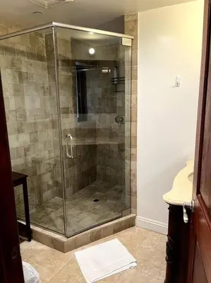 a shower with a glass door in a bathroom at Holiday at Halliday in Los Angeles