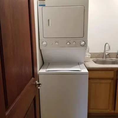a microwave sitting on top of a refrigerator in a kitchen at Holiday at Halliday in Los Angeles