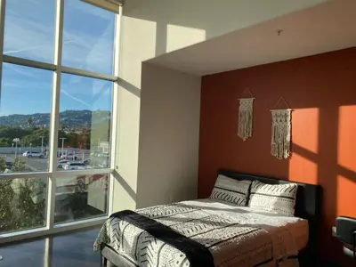 a bedroom with a bed and a large window at Spacious and Stylish unit in Los Angeles