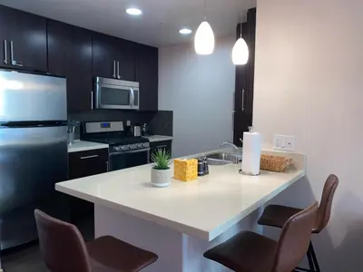 a kitchen with a white counter and a refrigerator at Spacious and Stylish unit in Los Angeles