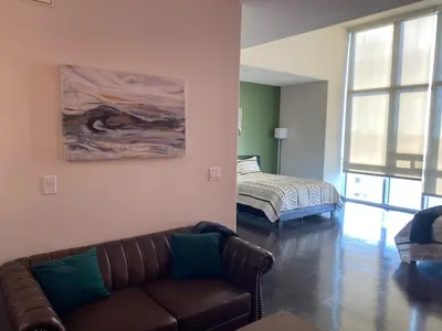 a living room with a couch and a bed at Spacious and Stylish unit in Los Angeles