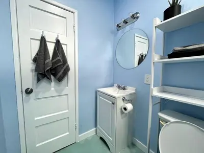 a bathroom with a white door and a sink at Serene Studio, Yurt Barn near DTLA Silverlake in Glendale