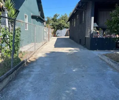 an empty street next to a building with a fence at Serene Studio, Yurt Barn near DTLA Silverlake in Glendale