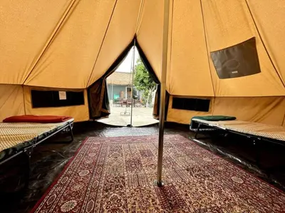 a tent with two beds and a rug in a room at Serene Studio, Yurt Barn near DTLA Silverlake in Glendale