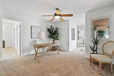 a living room with a desk and a ceiling fan at Beachfront 3 Bedroom 3 Bath In Seal Beal, Ca in Seal Beach