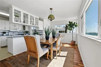 a kitchen with a wooden table and chairs in a room at Beachfront 3 Bedroom 3 Bath In Seal Beal, Ca in Seal Beach