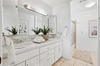 a white bathroom with a sink and a shower at Beachfront 3 Bedroom 3 Bath In Seal Beal, Ca in Seal Beach