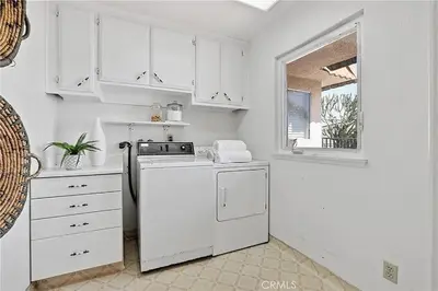 a white kitchen with a stove and a window at Beachfront 3 Bedroom 3 Bath In Seal Beal, Ca in Seal Beach