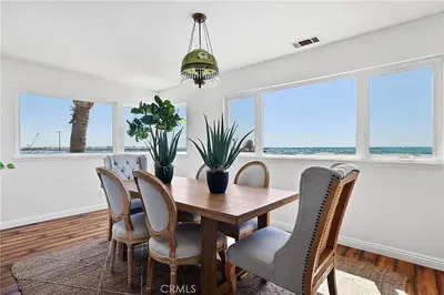 a dining room with a table and chairs at Beachfront 3 Bedroom 3 Bath In Seal Beal, Ca in Seal Beach