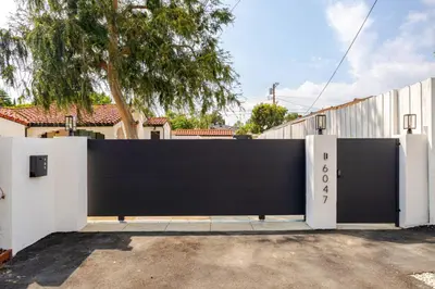a black and white gate in front of a house at Elegant Guest unit Universal sleeps 6 hot tub in Los Angeles