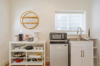 a small kitchen with a sink and a microwave at Elegant Guest unit Universal sleeps 6 hot tub in Los Angeles
