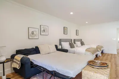 a living room with three beds and a couch at Elegant Guest unit Universal sleeps 6 hot tub in Los Angeles