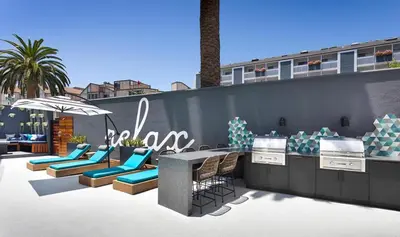a patio with chairs and a table and an umbrella at Redondo Beach 1BR w Pool Gym nr Beach LAX-398 in Redondo Beach