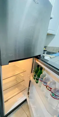 an open refrigerator with its door open and drinks inside at Lovely Sherman Oaks Studio in Los Angeles