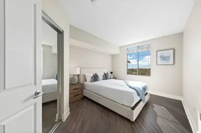 a white bedroom with a large bed and a window at Blue Topaz Retreat - Spacious 3BR Gorgeous City views in Los Angeles
