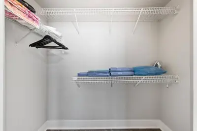 a white closet with a shelf and blue towels at Blue Topaz Retreat - Spacious 3BR Gorgeous City views in Los Angeles