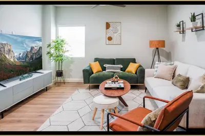 a living room with a couch and a table at Charming Disneyland Retreat - Sleeps up to 12 w Game Room, Pool Table, EV w King Bed in Midway City