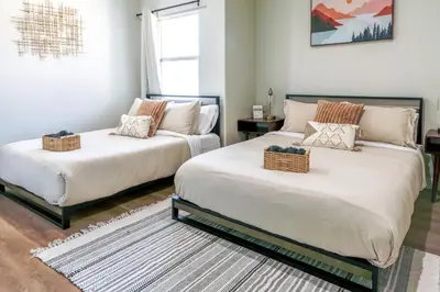 two beds sitting next to each other in a room at Cozy Luxe Unit Near Disneyland - Sleeps up to 10! EV Friendly & King Bed in Midway City