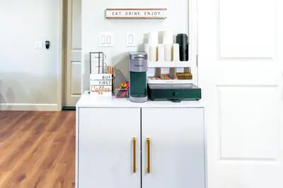 a white cabinet with a coffee maker on top of it at Cozy Luxe Unit Near Disneyland - Sleeps up to 10! EV Friendly & King Bed in Midway City