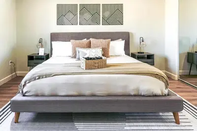 a bedroom with a large bed with a basket on it at Cozy Luxe Unit Near Disneyland - Sleeps up to 10! EV Friendly & King Bed in Midway City