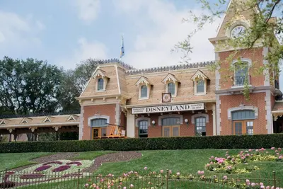 a large brick building with a clock tower on it at Cozy Luxe Unit Near Disneyland - Sleeps up to 10! EV Friendly & King Bed in Midway City