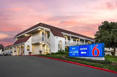 a building with a sign in front of it at Studio 6 Suites Carpinteria, CA Santa Barbara South in Carpinteria