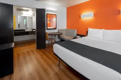 a hotel room with a bed and a bathroom at Studio 6 Suites Carpinteria, CA Santa Barbara South in Carpinteria