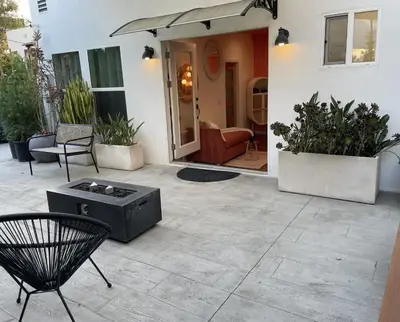 a patio with a bench and a table and chairs at Resort Getaway in Private Garden Terrace Villa w Luxury Amenities in Los Angeles