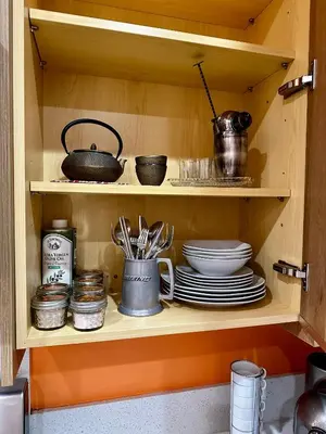 a kitchen cabinet with plates and utensils in it at Resort Getaway in Private Garden Terrace Villa w Luxury Amenities in Los Angeles