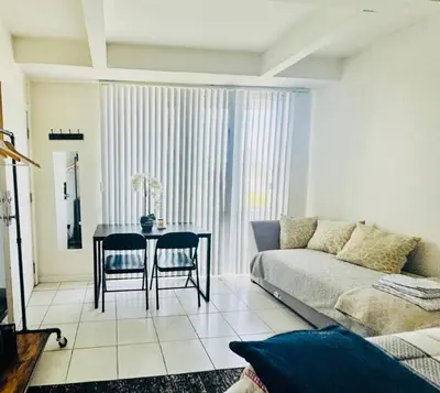 a living room with a couch and a table at Wonderful LA studio apartment in Los Angeles