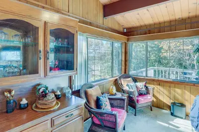 a room with two chairs and a table and windows at Spacious Crestline Retreat 1 Mi to Lake Gregory in Crestline
