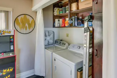 a small laundry room with a washer and dryer at Spacious Crestline Retreat 1 Mi to Lake Gregory in Crestline
