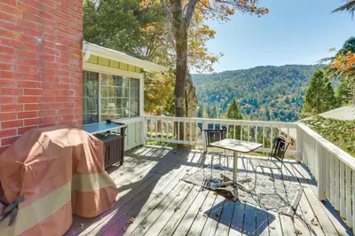 a deck with a table and chairs on a house at Spacious Crestline Retreat 1 Mi to Lake Gregory in Crestline
