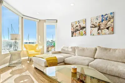 a living room with a couch and a glass table at The Coral Loft - Marina Bliss Water view 2BR Pool, Gym in Los Angeles