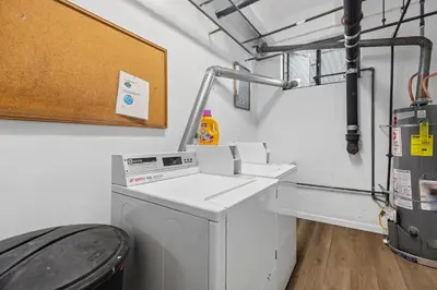 a laundry room with a washing machine and a sink at On the Boardwalk in Long Beach