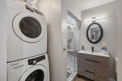 a washing machine in a bathroom with a sink at On the Boardwalk in Long Beach