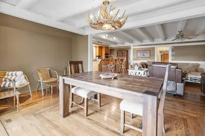 a dining room with a large wooden table and chairs at Serene Lakefront Haven by Rather Be Properties in Big Bear Lake