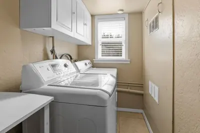 a small laundry room with a washer and dryer at Serene Lakefront Haven by Rather Be Properties in Big Bear Lake