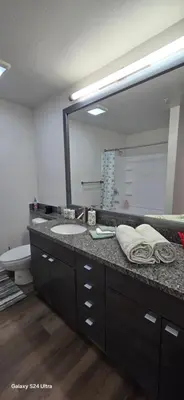 a bathroom with a sink and a large mirror at Large two-room apartment near LAX and the Ocean in Los Angeles