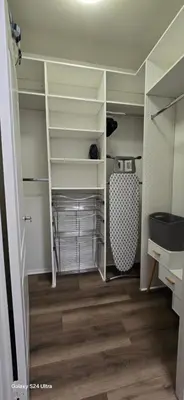 a closet with white shelves and a wooden floor at Large two-room apartment near LAX and the Ocean in Los Angeles