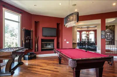 two pool tables in a room with red walls at Hills of Studio City, your serene home away from Home in Studio City