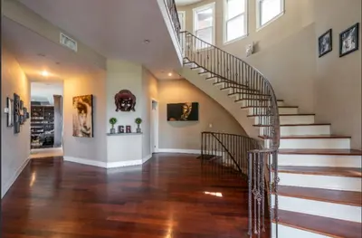 a spiral staircase in a home with wooden floors at Hills of Studio City, your serene home away from Home in Studio City