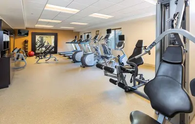 a gym with rows of treadmills and cardio machines at Homewood Suites by Hilton San Bernardino in San Bernardino
